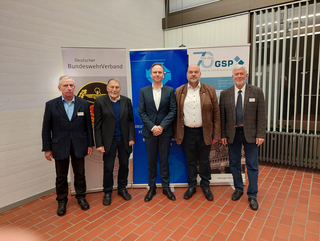 Fünf Männer stehen vor Bannern des Deutschen BundeswehrVerbandes und der Gesellschaft für Sicherheitspolitik.
