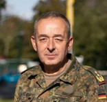 Porträt eines deutschen Militäroffiziers in Flecktarnuniform, blickt direkt zum Betrachter.