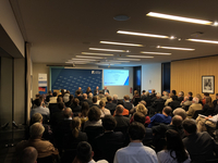 Ein Publikum nimmt an einer Podiumsdiskussion der Konrad-Adenauer-Stiftung zu Rüstungsexporten und Sicherheitspolitik teil.